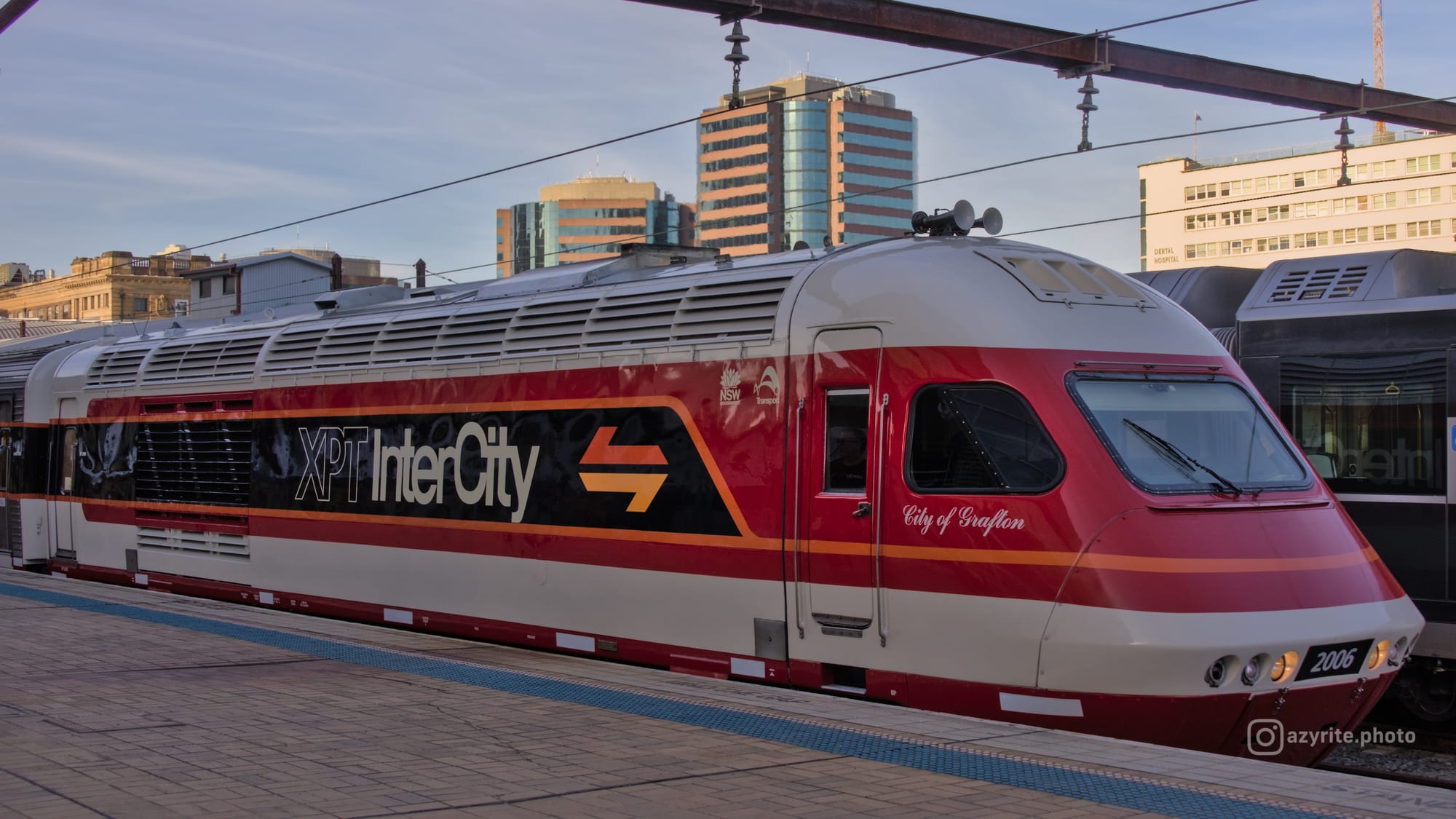 Side-view of candy liveried XPT power car 2006 named "City of Grafton" near the cab and with "XPT InterCity" on the side