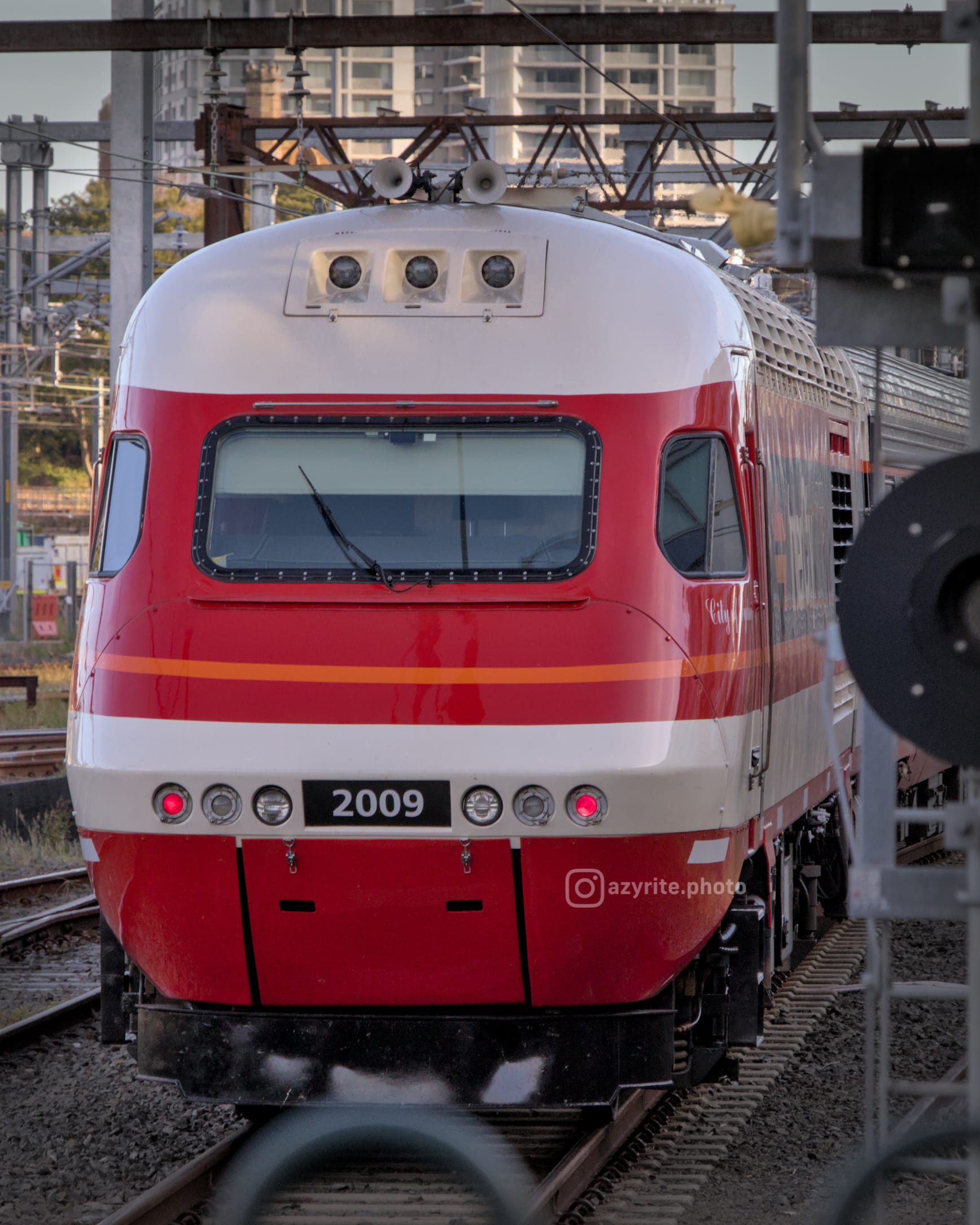 Front-on view of candy liveried XP 2009 at the rear of the train 