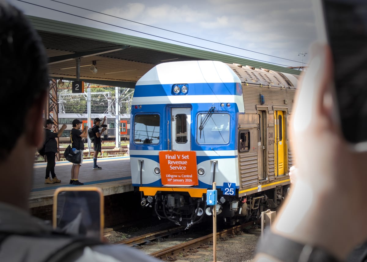Photographers capture the terminal end of V25 in its royal blue & white livery as the consist leaves Central 